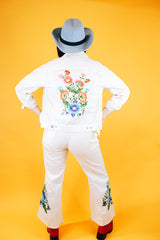 white jacket and pant set with floral embroidery throughout vintage women's 1970's