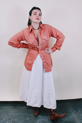 Men's or women's vintage western style 1970's Ely Plains Rider, Ely C. Walker USA label long sleeve shirt with pearl snapper buttons, chest pockets, dagger collar in orange with rose print.