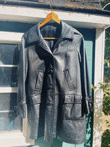long sleeve black long leather jacket, collar and buttons up the front vintage 1960's