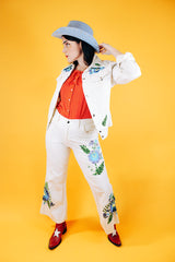 white jacket and pant set with floral embroidery throughout vintage women's 1970's