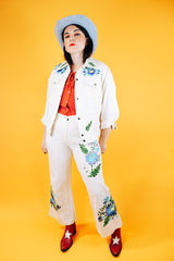 white jacket and pant set with floral embroidery throughout vintage women's 1970's