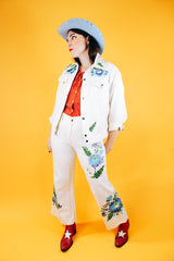 white jacket and pant set with floral embroidery throughout vintage women's 1970's