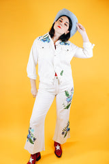 white jacket and pant set with floral embroidery throughout vintage women's 1970's