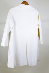 Women's vintage 1960's Lilli Ann, Paris & San Francisco label 3/4 arm length long length cream colored vinyl polyester coat with big round gold buttons and four front pockets