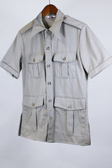 Women's or men's vintage safari style 1970's Montgomery Ward label short sleeve button up tan colored shirt in cotton with four pockets, dagger collar, side slits, and wood buttons.