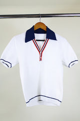 Women's or men's vintage 1970's short sleeve white top with navy collar, two button half closure in a nubby textured stretchy polyester material.