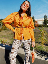 long sleeve puff sleeve orange button up blouse with ruffle front trim and pointy collar women's vintage 1970's