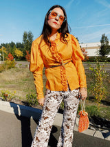 long sleeve puff sleeve orange button up blouse with ruffle front trim and pointy collar women's vintage 1970's
