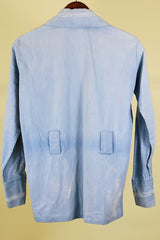 Women's or men's vintage 1970's long sleeve light wash denim shirt with popper buttons, pockets, belt loops, and floral embroidery throughout.