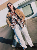 Men's vintage 1970's long sleeve button up shirt with a pointy collar in a lightweight Polyester material. White with all over brown floral print.