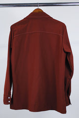 Men's vintage 1970's Time Out West by Farah, Made in USA label long sleeve maroon colored polyester western style shirt with pearl popper buttons and white contrast stitching.