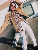 Men's vintage 1970's long sleeve button up shirt with a pointy collar in a lightweight Polyester material. White with all over brown floral print.