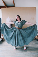 Women's vintage 1940's short sleeve maxi length cotton material prairie style dress with white and black ribbon trim around neckline and cuffs. Scalloped hem.