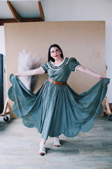 Women's vintage 1940's short sleeve maxi length cotton material prairie style dress with white and black ribbon trim around neckline and cuffs. Scalloped hem.