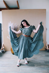 Women's vintage 1940's short sleeve maxi length cotton material prairie style dress with white and black ribbon trim around neckline and cuffs. Scalloped hem.