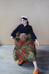 Women's vintage 1960's Lounging Apparel Evelyn Pearson label long sleeve maxi length twofer house dress with a black velvet top part and multicolored floral print skirt.