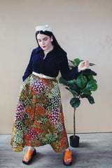 Women's vintage 1960's Lounging Apparel Evelyn Pearson label long sleeve maxi length twofer house dress with a black velvet top part and multicolored floral print skirt.