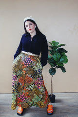 Women's vintage 1960's Lounging Apparel Evelyn Pearson label long sleeve maxi length twofer house dress with a black velvet top part and multicolored floral print skirt.