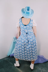 Women's vintage 1980's blue polyester dress with a white lace overlay. Has sheer puff sleeves, side zipper, low cut back, and a lace bow in the back