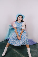 Women's vintage 1980's blue polyester dress with a white lace overlay. Has sheer puff sleeves, side zipper, low cut back, and a lace bow in the back