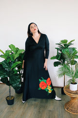 Women's vintage 1970's long sleeve maxi length black polyester material dress with big red and green flower graphic on the side