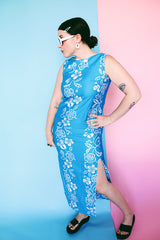 Women's vintage 1960's Made in Hawaii for Andrade Resort Shops Waikiki label sleeveless ankle length blue Hawaiian print dress with all over white floral print and white trim.