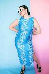 Women's vintage 1960's Made in Hawaii for Andrade Resort Shops Waikiki label sleeveless ankle length blue Hawaiian print dress with all over white floral print and white trim.