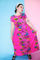 Women's vintage 1960's Skirts & Blouses Specialty Shop Honolulu label short sleeve ankle length bright pink cotton material dress with all over Hawaiian floral print.