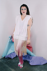 Women's vintage 1980's sleeveless mini length white dress with a drop waist and fringe overlay on bottom skirt.