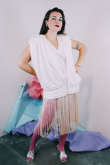 Women's vintage 1980's sleeveless mini length white dress with a drop waist and fringe overlay on bottom skirt.