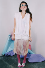 Women's vintage 1980's sleeveless mini length white dress with a drop waist and fringe overlay on bottom skirt.