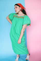 Women's vintage 1970's short sleeve cotton material green short sleeve ankle length dress with orange embroidery and a square neckline and puff sleeves.