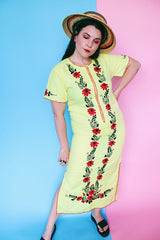 Women's vintage 1970's Wendy-Ann Inc. label short sleeve ankle length cotton material dress in bright yellow with all over red and black embroidered floral design.