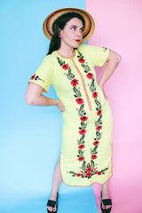 Women's vintage 1970's Wendy-Ann Inc. label short sleeve ankle length cotton material dress in bright yellow with all over red and black embroidered floral design.