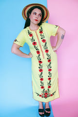 Women's vintage 1970's Wendy-Ann Inc. label short sleeve ankle length cotton material dress in bright yellow with all over red and black embroidered floral design.