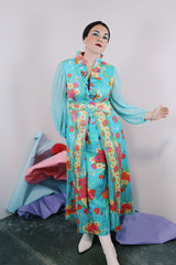 Women's vintage 1970's long sleeve ankle length dress in blue with all over orange and pink floral print.