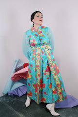 Women's vintage 1970's long sleeve ankle length dress in blue with all over orange and pink floral print.