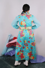 Women's vintage 1970's long sleeve ankle length dress in blue with all over orange and pink floral print.