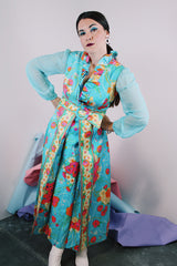 Women's vintage 1970's long sleeve ankle length dress in blue with all over orange and pink floral print.