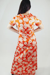 short sleeve maxi length orange printed dress with ruffle trim vintage 1970's