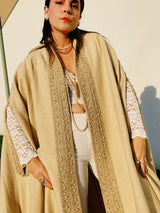 beige wool poncho ape with beaded and gold ribbon trim and pointy collar vintage women's 1960's