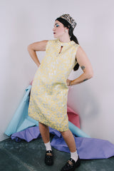 Women's vintage 1960's R & K Originals label sleeveless knee length shift dress in yellow with all over floral silver metallic embroidery.