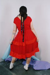 Women's vintage 1960's short sleeve capped sleeve knee length midi dress in vibrant red with a scoop neckline and flower on chest.