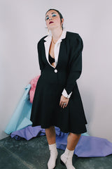 Women's vintage 1980's cotton waffle knit long sleeve knee length midi dress in black with whit double lapel collar and white trim on cuffs.