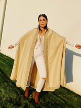beige wool poncho ape with beaded and gold ribbon trim and pointy collar vintage women's 1960's