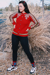 long sleeve wool red norwegian sweater with white and green print with silver buttons up the front