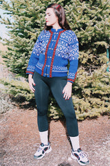 long sleeve wool blue norwegian sweater with white print and red trim and silver metal claps buttons