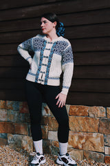 long sleeve white norwegian sweater with blue print and silver metal buttons