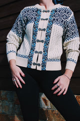 long sleeve white norwegian sweater with blue print and silver metal buttons