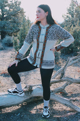 long sleeve wool Norwegian sweater with silver metal closures for buttons cream with brown, green, and orange print